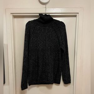 Black with metallic silver turtle neck sweater.